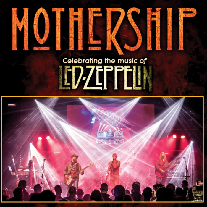 Livefoto van Britse band Mothership, in een zaal vol publiek en krachtige lichtshow.