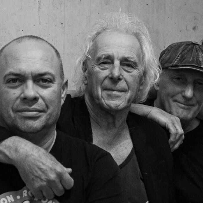 De foto is zwart wit, in de foto zijn de bandleden van Bintangs te zien. Ze leunen allemaal op elkaars schouders terwijl ze naast elkaar staan.