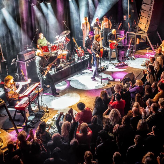 Bouke en The Elvis Matters Band spelen voor een volle zaal, ondersteund door een levendige lichtshow vanaf het podium.